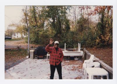 Morris (Chris) Walker waving on a patio