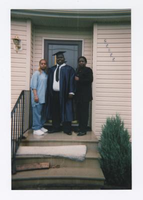 Jawan Harris with mother and friend on his graduation day