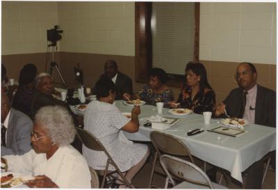 LaMonte Cooke with a Group Enjoying a Meal at a Religious Gathering