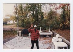 Morris (Chris) Walker waving on a patio