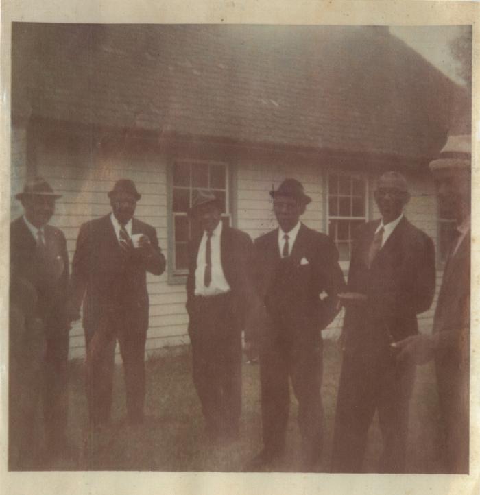 Group of Men in Suits Outside the Worton Point Schoolhouse