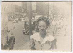 Black and White Photo of a Woman near a Street