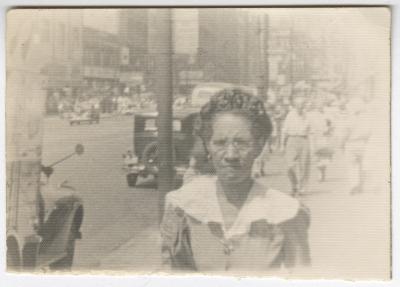 Black and White Photo of a Woman near a Street