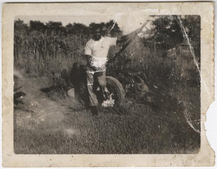 Old Photograph of a Man with a Piece of Farm Equipment 