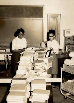 Detail of Mrs. Marie Brown, Home Economics Teacher, and students in a Kennard High School classroom
