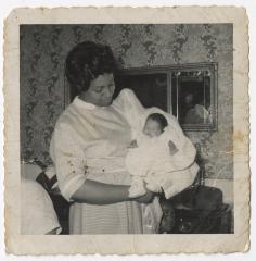 A Black and White Photo of a Woman Holding an Infant