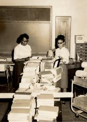 Detail of Mrs. Marie Brown, Home Economics Teacher, and students in a Kennard High School classroom