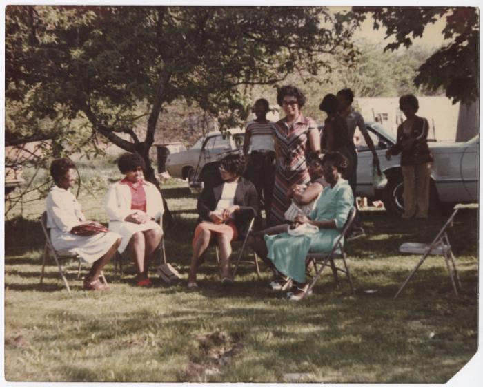 A Group of Ladies Sitting Outside 