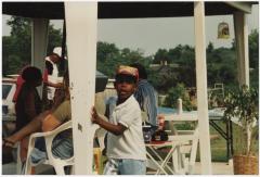 Photo of a Young Boy Playing Outside During an Outdoor Gathering