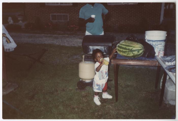 A Toddler Outside During a Gathering