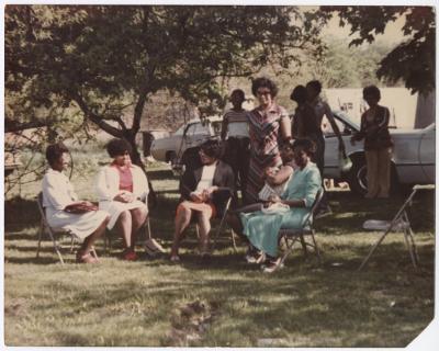A Group of Ladies Sitting Outside 