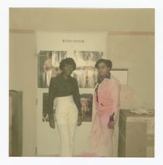Eleanor Rochelle Ringgold and friend posing in front of posters