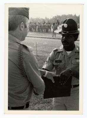 Two men in uniform shaking hands 