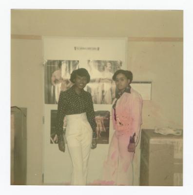 Eleanor Rochelle Ringgold and friend posing in front of posters