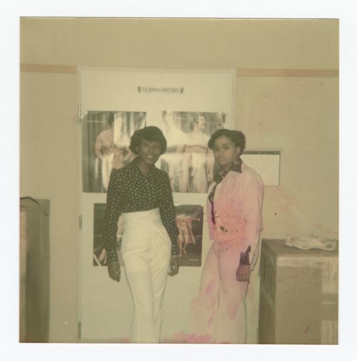 Eleanor Rochelle Ringgold and friend posing in front of posters