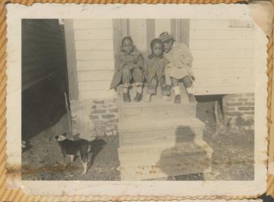 Claudine Dotson, Vanessa Dotson, and Valerie Bessick sitting on the steps