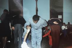Debutante Escort practices his bow and his debutante's curtsy during dance practice session, 1989