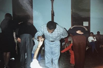 Debutante Escort practices his bow and his debutante's curtsy during dance practice session, 1989