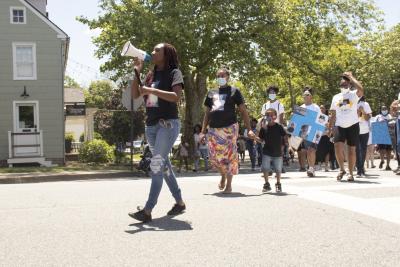 Woman leading march with bullhorn