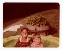 Kanisa Johnson and Shawn Bogardus sitting in children's pool
