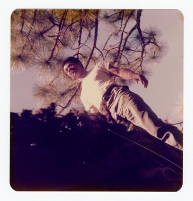 A man standing, pictured from below