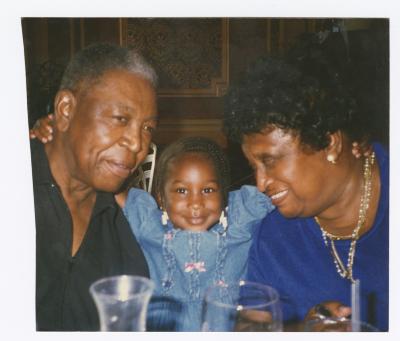 Imani Briscoe with her arms around grandparents Oliver and Solistine Briscoe